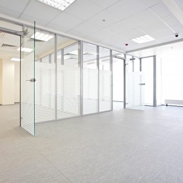 Empty office hall with glass walls and doors