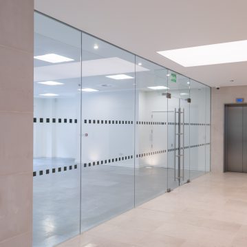 Glass partitioning and lift in empty workplace